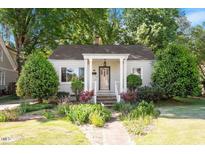 Charming single-story home with a welcoming front porch and beautifully landscaped front yard at 708 Mills St, Raleigh, NC 27608