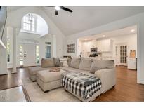 Inviting living room with vaulted ceiling, hardwood floors and view to the kitchen at 100 Bradborne Cir, Clayton, NC 27520