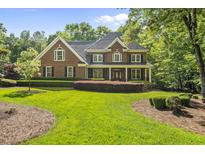 Beautiful brick home with manicured lawn and lovely landscaping at 10825 Rondeau Woods Ct, Raleigh, NC 27614