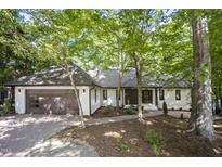Charming single-story home with a brick driveway, attached garage, and a well-manicured front yard at 109 Lochview Dr, Cary, NC 27518