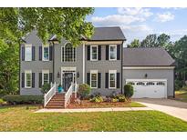 Beautiful two-story home featuring a manicured lawn, attached two-car garage, and classic curb appeal at 116 Dallavia Ct, Morrisville, NC 27560