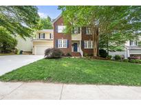Charming two-story home boasts a brick and siding facade, complemented by a well-manicured lawn at 13017 Townfield Dr, Raleigh, NC 27614