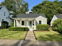 Charming one-story home with a well-manicured lawn, inviting front porch, and vibrant landscaping at 1510 Hanover St, Raleigh, NC 27608