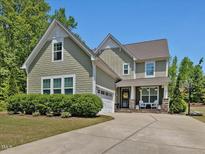 Charming two-story home featuring a well-manicured lawn, inviting front porch and a spacious driveway at 1701 Bodwin Ln, Apex, NC 27502