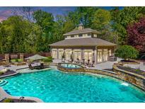Stunning pool and spa with outdoor seating and beautiful landscaping create a relaxing oasis at 187 Stoney Creek Way, Chapel Hill, NC 27517
