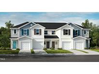 Beautiful new construction townhomes with attached garages and manicured lawns at 2015 Oakdale Dr, Durham, NC 27703