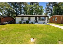 Charming, freshly painted home with a well-manicured lawn and inviting curb appeal at 2311 Wintergreen Pl, Durham, NC 27707