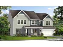 Charming two-story home featuring a covered porch, gray siding, and an attached two-car garage at 264 Alden Way, Angier, NC 27501