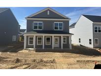 New two-story home featuring a charming front porch with white columns and gray siding at 2868 Quarry Rd # 167, Rolesville, NC 27571