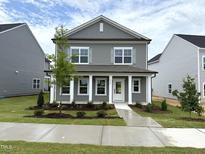 Charming two-story home boasts a well-manicured lawn and classic architectural details at 2868 Quarry Rd # 167, Rolesville, NC 27571