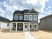 Charming two-story home featuring gray siding, white trim, and a welcoming front porch at 2872 Quarry Rd # 166, Rolesville, NC 27571