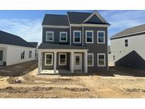 Charming two-story home featuring a covered porch and multiple windows, awaiting landscaping at 2872 Quarry Rd # 166, Rolesville, NC 27571