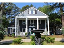 Charming two-story home with a covered porch and landscaped front yard at 300 S Pine St, Benson, NC 27504