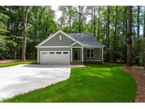 Charming home with attached garage, beautiful lawn and surrounded by mature trees at 3258 Yorkshire Cir, Sanford, NC 27332