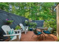 Charming brick back patio with outdoor seating and lush, mature landscaping provides a private outdoor oasis at 35 Stonewall Way, Durham, NC 27704