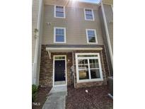 Charming townhome featuring a stone facade and well-maintained landscaping at 351 Gilman Ln # 109, Raleigh, NC 27610