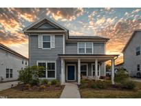 Charming two-story home with a covered front porch and beautifully landscaped yard at 5009 Megara, Raleigh, NC 27603