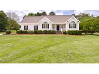 Charming single-story home with manicured lawn and inviting front porch, perfect for relaxing and enjoying the outdoors at 608 Elin Ct, Hillsborough, NC 27278