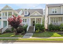 Charming home with landscaped front yard, welcoming front porch, and inviting curb appeal at 706 Great Ridge Pkwy, Chapel Hill, NC 27516