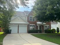 Charming brick home with a two-car garage and well-manicured front lawn at 110 Bristolwood Cir, Morrisville, NC 27560