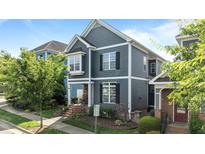 Charming two-story home with gray siding, white trim, and front yard landscaping at 1209 Harp St, Raleigh, NC 27604