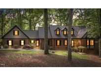 Charming brick home with well-manicured lawn and mature trees at 12537 Birchfalls Dr, Raleigh, NC 27614