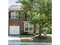 Charming brick townhome featuring a one-car garage and well-maintained front yard at 1909 Whirlaway Ct., Cary, NC 27519