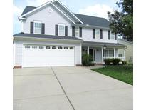 Charming two-story home with a two-car garage and well-maintained landscaping, perfect for Gathering living at 202 Redstone Ct, Gibsonville, NC 27249