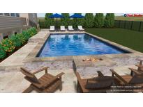 A stunning pool with lounge chairs, umbrellas, and fire pit offers a relaxing outdoor space at 25 Westbourne Ln, Youngsville, NC 27596