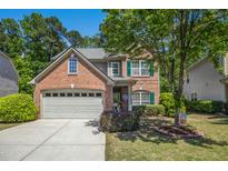 Charming two-story brick home featuring a two-car garage and a well-manicured front lawn at 3633 Willow Stone Ln, Wake Forest, NC 27587