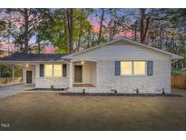 Charming single-story home featuring painted brick, modern fixtures, covered parking, and a well-maintained front yard at 3907 Inwood Dr, Durham, NC 27705