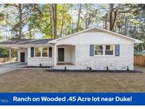 Charming ranch-style home with a covered carport and white-painted brick exterior at 3907 Inwood Dr, Durham, NC 27705