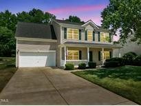 Charming two-story home with green shutters, covered porch, and well-maintained lawn at 4805 Ayden Mill Rd, Apex, NC 27539