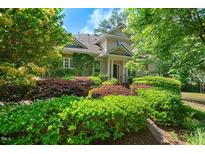 Charming home with mature landscaping, including colorful shrubbery and lush greenery at 51 Abernathy Dr, Chapel Hill, NC 27517