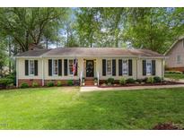 Charming single-story home with a well-manicured lawn and inviting curb appeal at 5709 Lakehaven Dr, Raleigh, NC 27612
