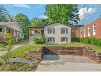 Charming home featuring white painted brick, dark shutters, a cozy front porch, and ample parking at 623 Massey Ave, Durham, NC 27701