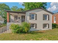 Charming white brick home featuring a cozy front porch and well-maintained yard at 623 Massey Ave, Durham, NC 27701