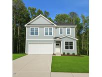 Charming two-story home with a two-car garage, manicured lawn, and beautiful landscaping at 629 Conover Rd, Durham, NC 27703