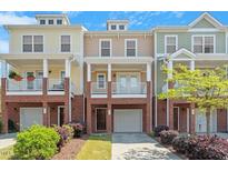 Charming townhome exterior with brick accents, inviting porches, and well-manicured landscaping at 710 Samuel Cary Dr, Cary, NC 27511