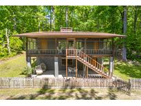 Charming two-story home featuring a screened-in porch and wooded backyard views at 7723 Johnson Mill Rd, Bahama, NC 27503