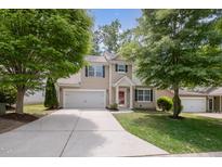 Charming two-story home with a manicured lawn, a two-car garage, and a welcoming red front door at 809 Amarillo Rose Ln, Durham, NC 27712