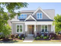 Charming home exterior featuring a covered porch, stone accents, and well-maintained landscaping at 92 Cardinal Ridge Rd, Chapel Hill, NC 27516