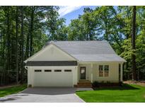 Charming home featuring an attached garage, well-manicured lawn, and inviting front entrance at Lot 3260 Yorkshire Cir, Sanford, NC 27332