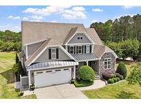 Stunning two-story home with manicured lawn, stone accents and attached two car garage at 10 Princeton Manor Dr, Youngsville, NC 27596
