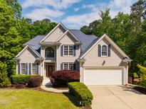 Charming two-story home featuring a manicured lawn and a two-car garage at 100 Panoramic Ct, Cary, NC 27519