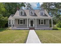 Charming home featuring gray siding, a welcoming front porch, and manicured green lawn with a concrete walkway at 1331 Sunset Ave, Rocky Mount, NC 27804