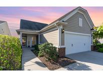 Charming home featuring a two-car garage, well-maintained landscaping, and a welcoming entrance at 1522 Palmer Hill Dr, Durham, NC 27703