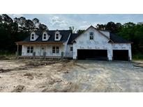 Exterior of a new home build with two-car garage and black roof at 196 Cozy Brook Ct, Clayton, NC 27520