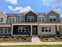 Charming townhome exterior with well-maintained landscaping and inviting curb appeal on a sunny day at 2917 Alyssa Ct, Knightdale, NC 27604