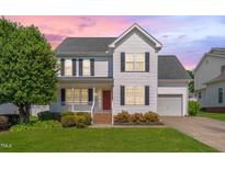 Charming two-story home with a well-manicured lawn, inviting porch, and a classic design at 3315 Swinford Ct, Raleigh, NC 27604